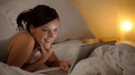 Frau surft im Hotelzimmer im Internet